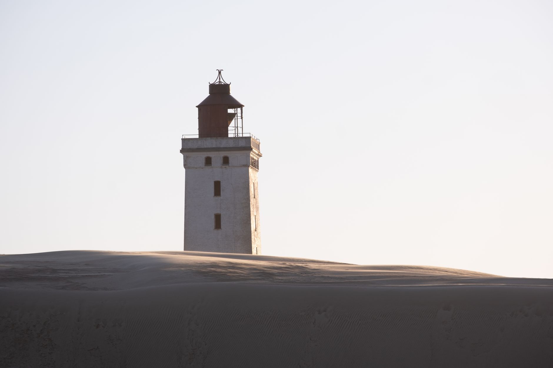 Scenic view of Rubjerg Knude Lighthouse rising above the dunes in Løkken, Denmark.